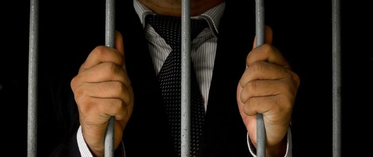 businessman behind bars