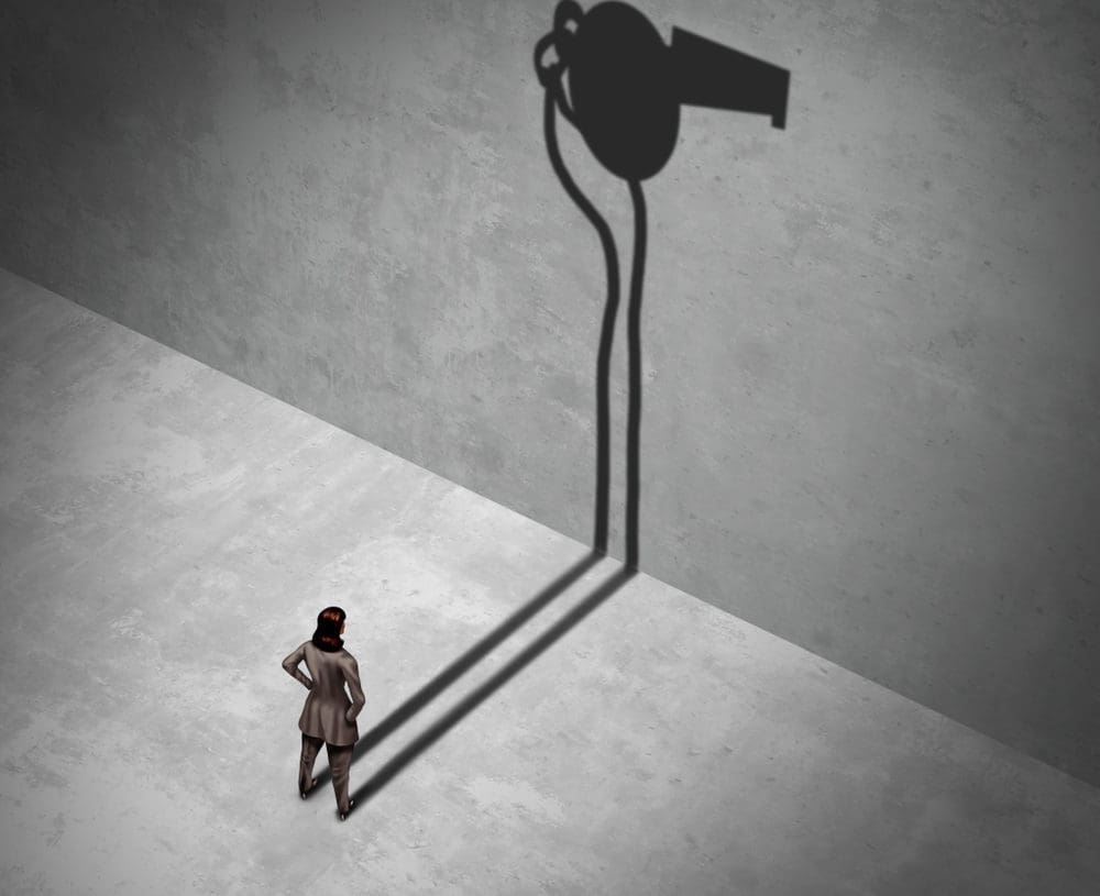 woman contemplating blowing a whistle