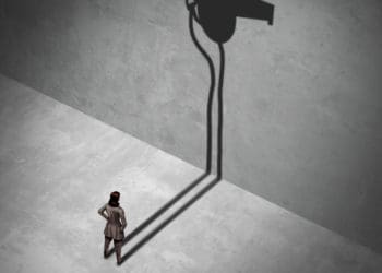 woman contemplating blowing a whistle