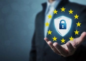 GDPR shield and EU stars in businessman's hand