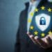 GDPR shield and EU stars in businessman's hand