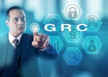 businessman pushing virtual GRC button