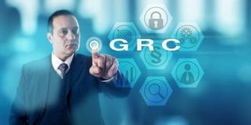 businessman pushing virtual GRC button
