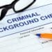 closeup of background check form with glasses