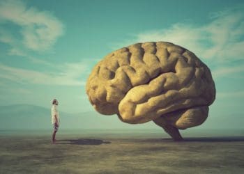 man facing giant brain