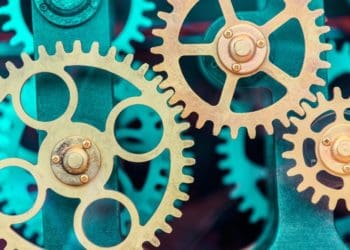 gold interlocking gears on green background