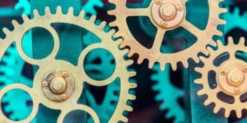 gold interlocking gears on green background