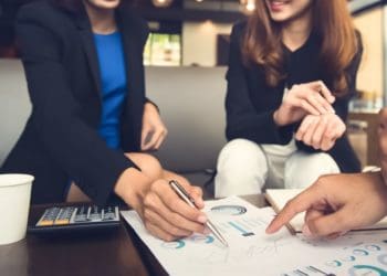 investment adviser sitting with professional clients