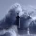 giant waves crashing around lighthouse in a storm