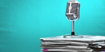 microphone on stack of newspapers