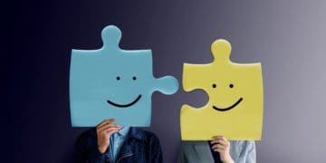 two businesspeople with puzzle pieces as heads