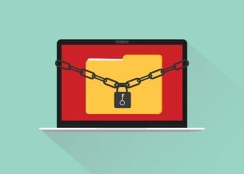 ransomware concept illustration with file folder on laptop secured with chain and padlock