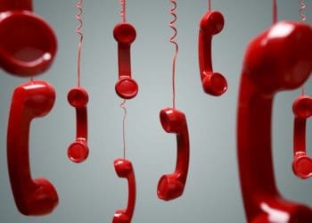red phones hanging by their cords