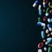 falling tablets and capsules on dark blue background