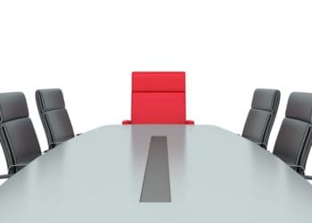 red, empty chair at board room table