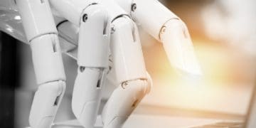 robot hand on keyboard