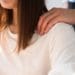 closeup of man's hand on woman's shoulder