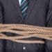 businessman bound with rope