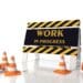 traffic cones surround work in progress sign