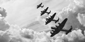 black and white retro image of WW2-era bombers flying in formation