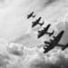 black and white retro image of WW2-era bombers flying in formation