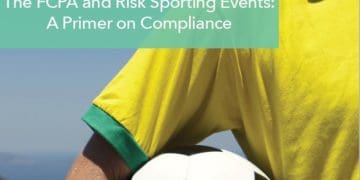 Man holding soccer ball in crook of his arm