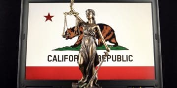 symbol of law and justice with California State Flag on laptop