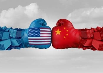 U.S. and Chinese flags on opposing boxing gloves representing trade war