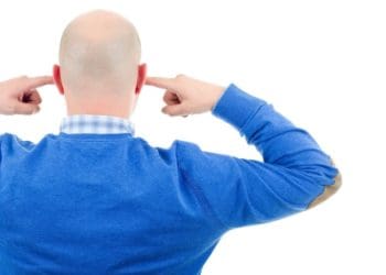 back view of man plugging his ears