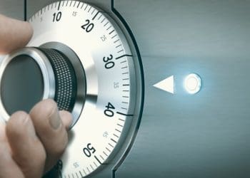 hand turning dial on a safe