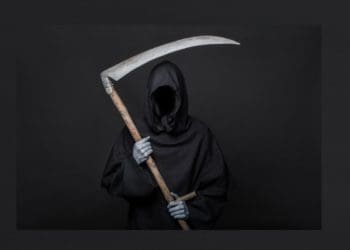 grim reaper holding scythe on dark gray background