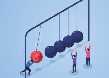 figure putting newton's cradle in motion