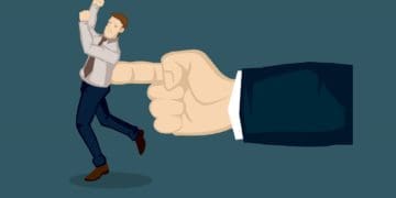 giant hand pushing businessman with one finger