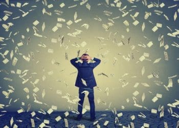 back view of man with cash falling around him