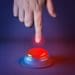 hand prepared to push glowing red button