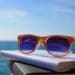 sunglasses on stack of books at the beach