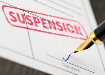 red suspension stamp on official form