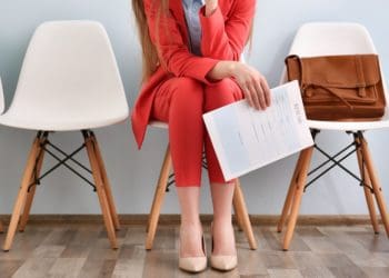 woman in red suit waiting for an interview