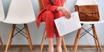 woman in red suit waiting for an interview