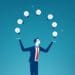 businessman juggling light bulbs