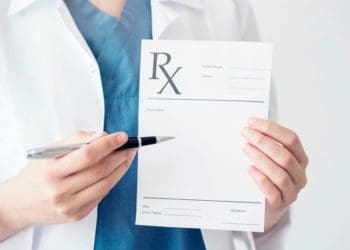 doctor holding prescription pad