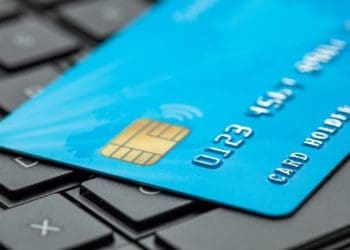 blue credit card on black laptop keyboard