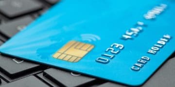 blue credit card on black laptop keyboard