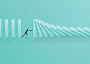 illustration of businessman stopping falling dominoes