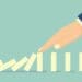 illustration of hand stopping falling dominos