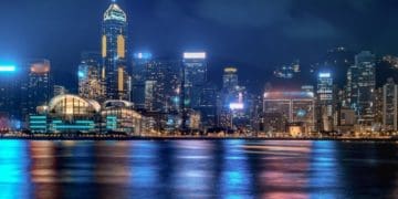 Hong Kong cityscape at night with lights reflecting in Victoria Harbour