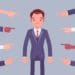 illustration of many hands pointing to businessman looking distressed