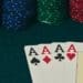 four aces on card table with stacks of poker chips