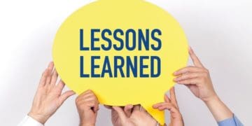group of co-workers holding "lessons learned" speech bubble