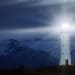 lighthouse shining beacon at night